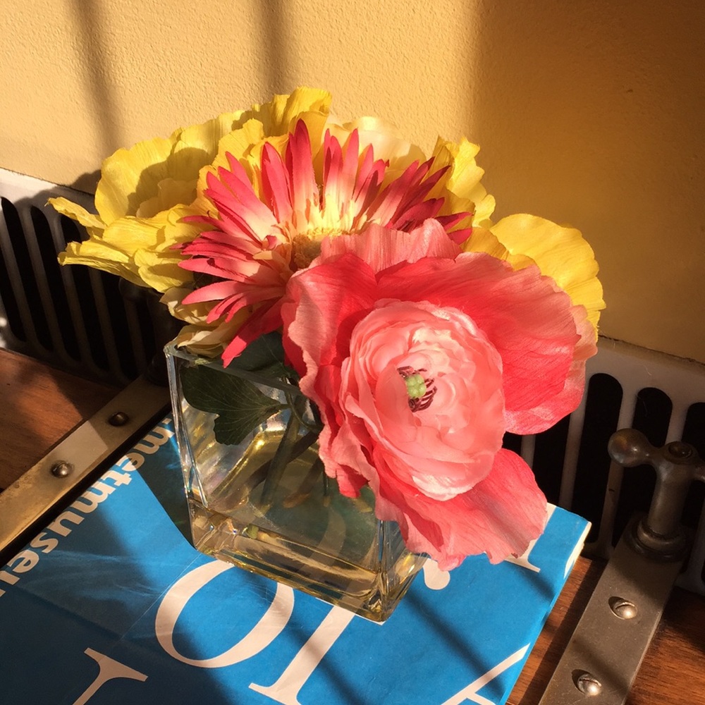 Artificial yellow and pink flowers in faux water